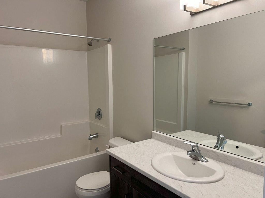 a bathroom with a sink toilet and a mirror