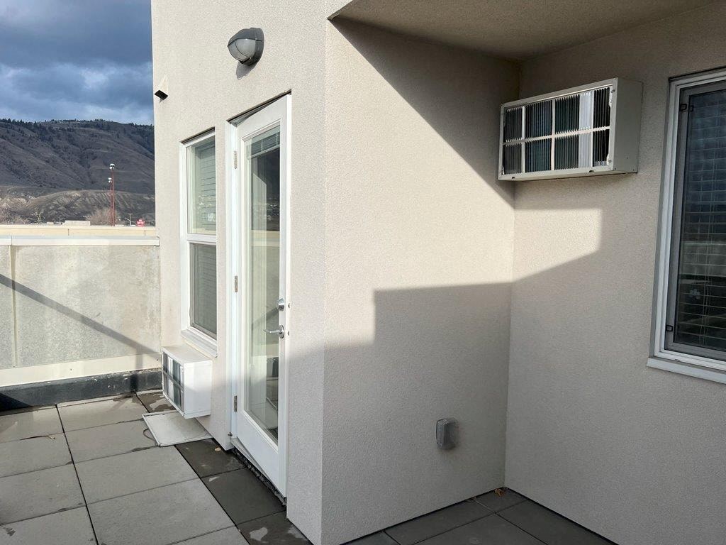 a balcony with a door and a patio