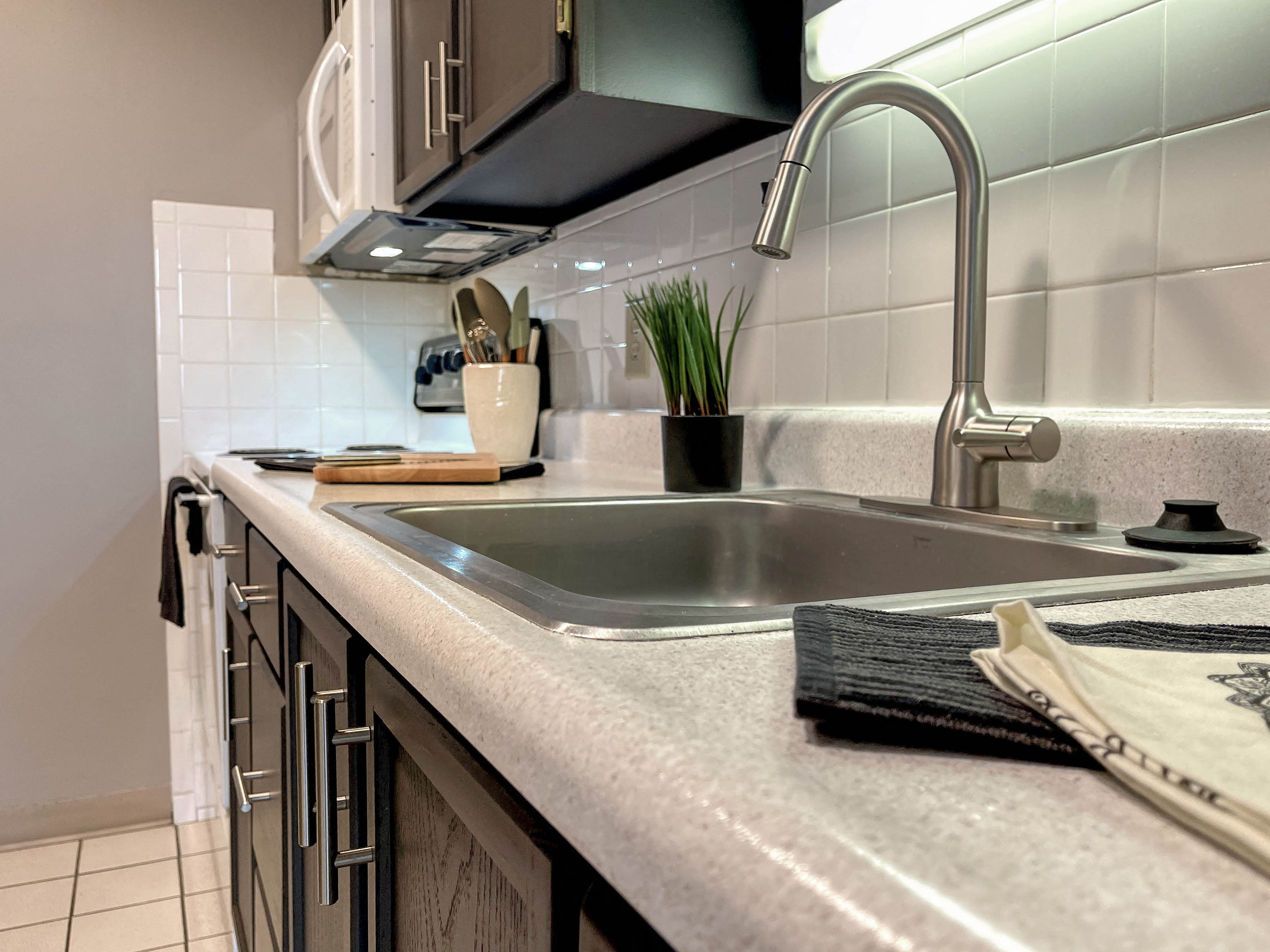 a kitchen counter with a sink and a faucet