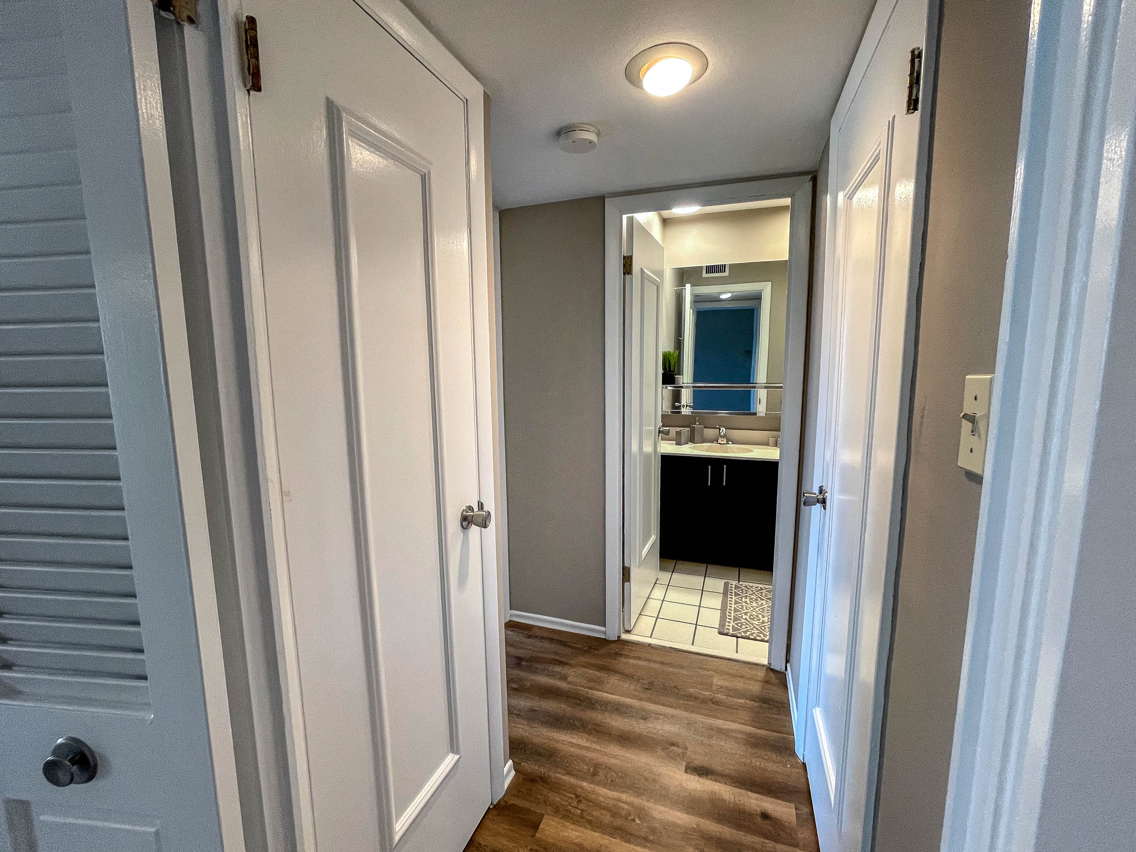 a view of the hallway from the closet into the bathroom with the door open