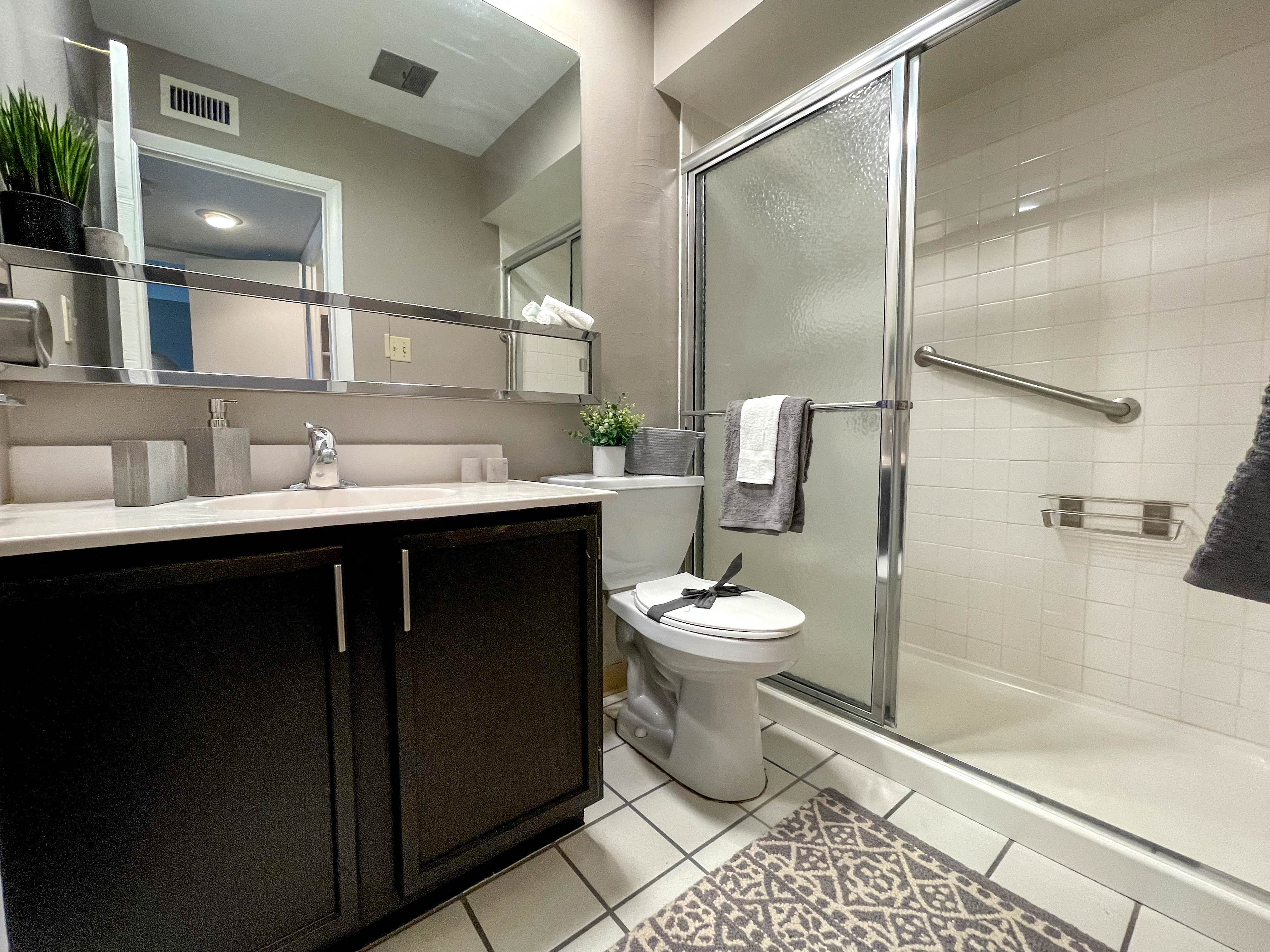 a bathroom with a toilet and a shower