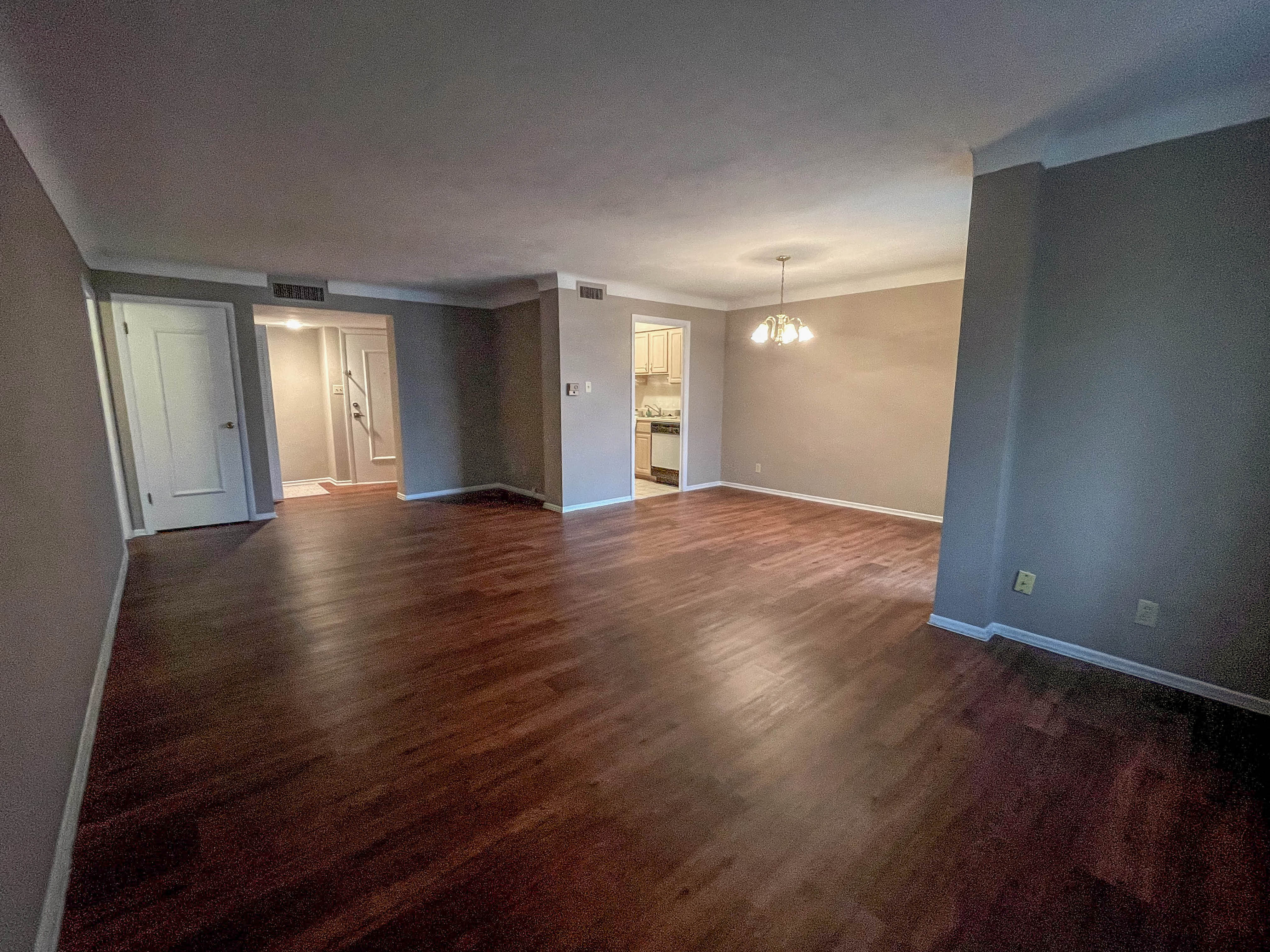 an empty living room with a hard wood floor