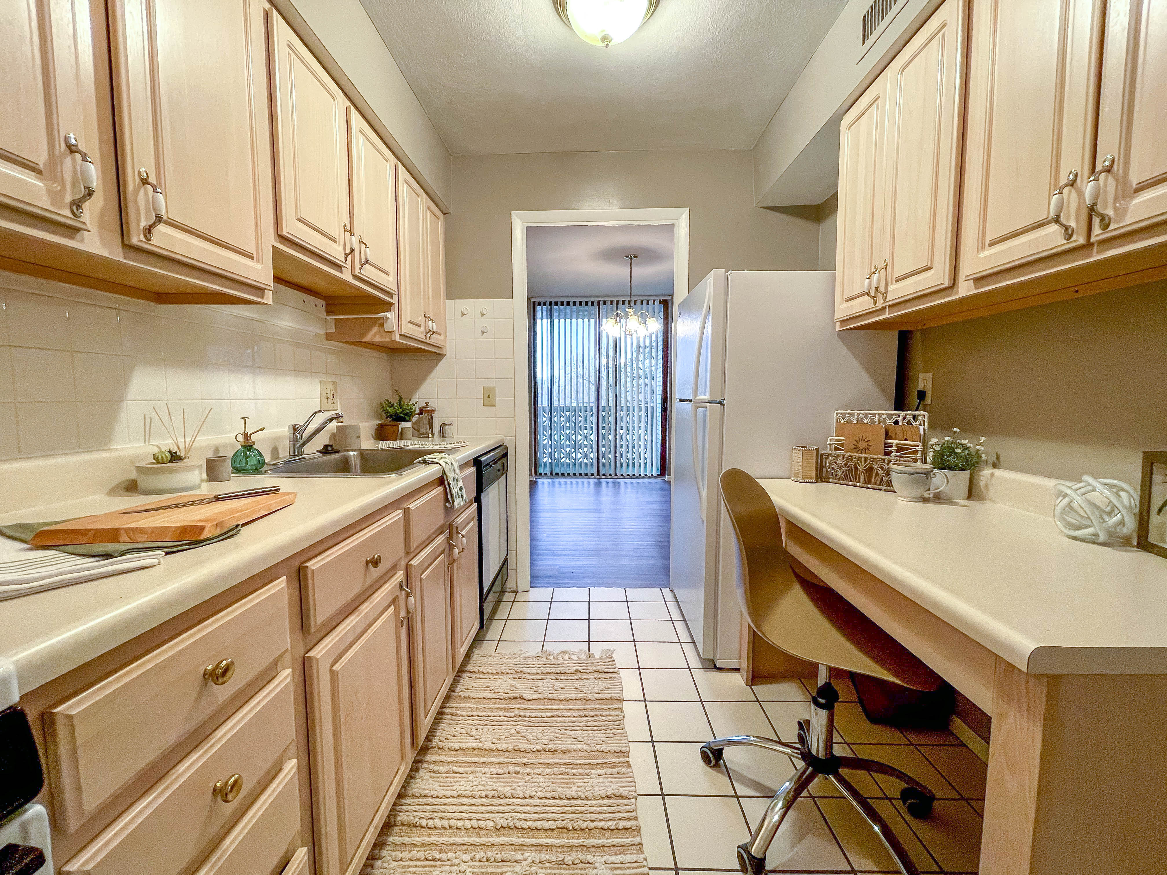 a kitchen with wooden cabinets and a counter top and a sink