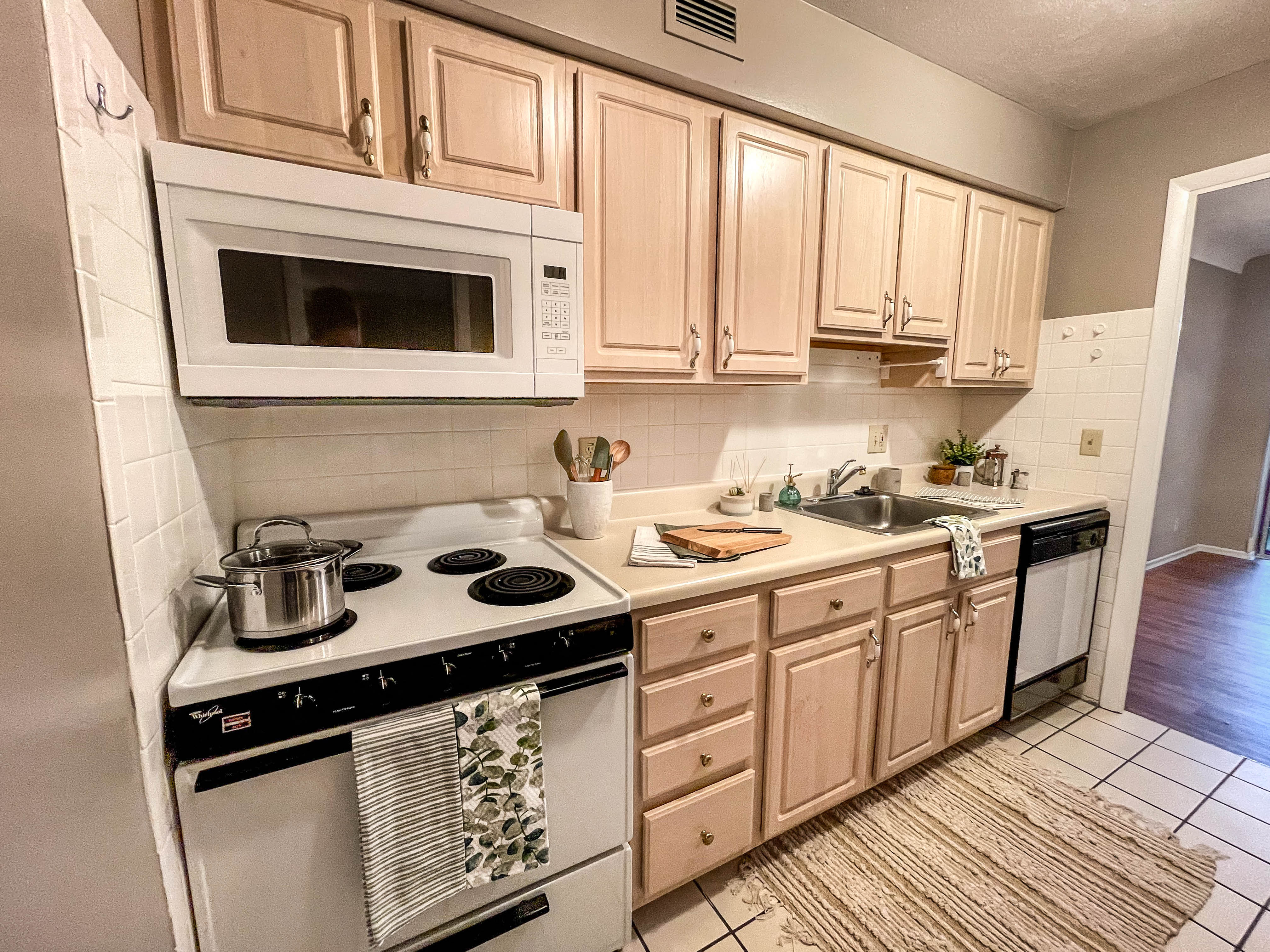 a kitchen with a stove microwave and sink