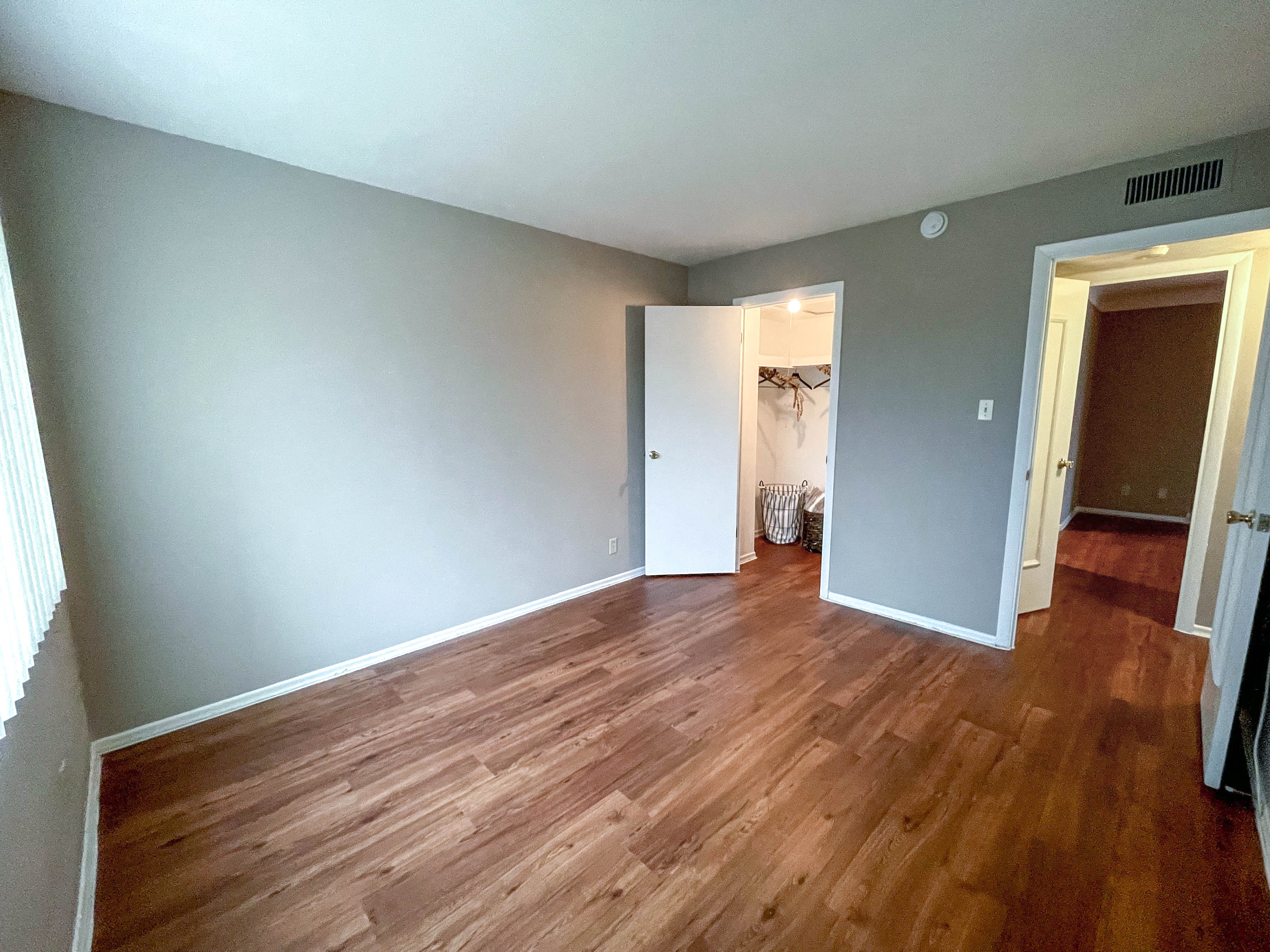a living room with a hard wood floor and blue walls