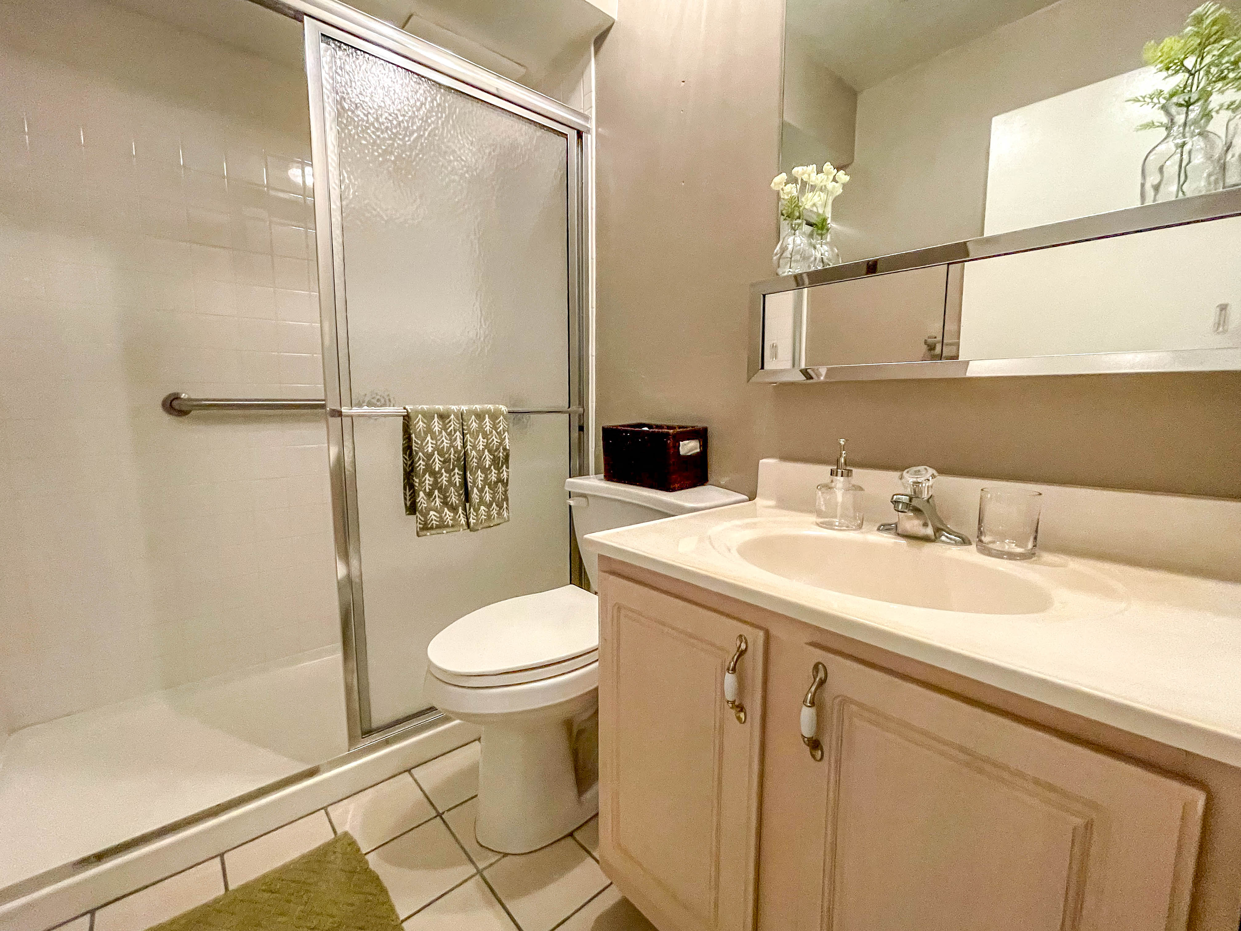 a bathroom with a sink toilet and shower