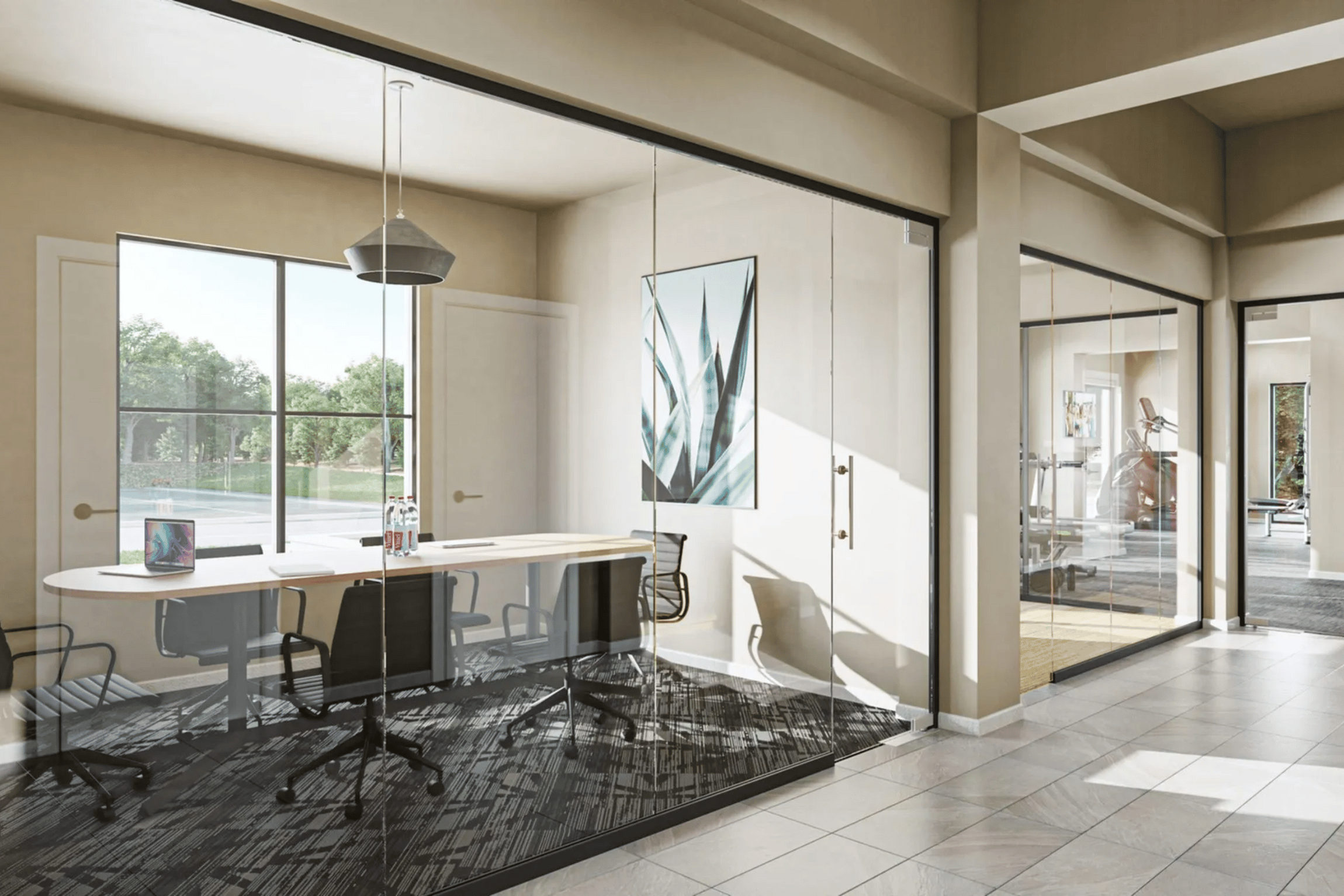 A modern office space with a large desk and chairs.