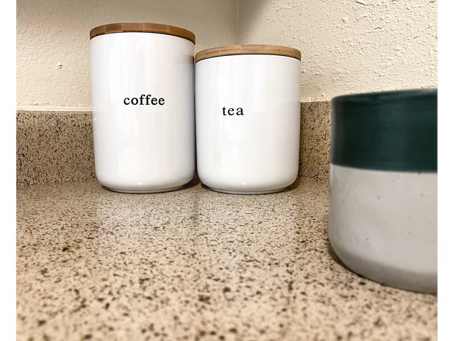 three coffee cups sitting on a kitchen counter