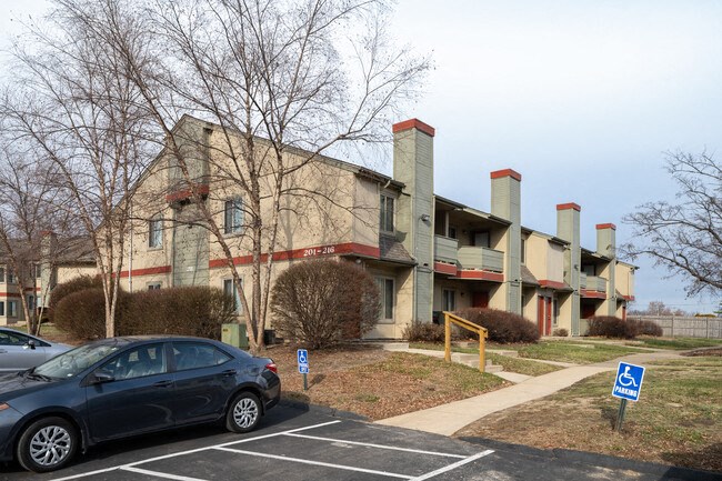 an apartment building with a car parked in front of it