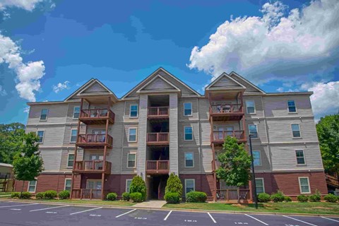 exterior view of three story apartment building with balconies