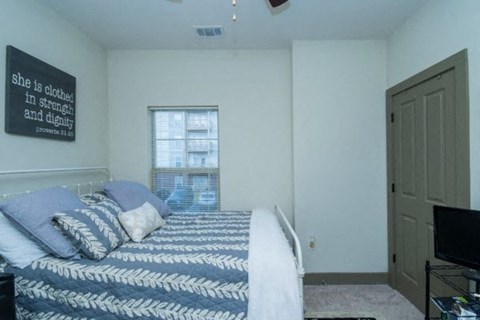 a bedroom with a bed and a television in it