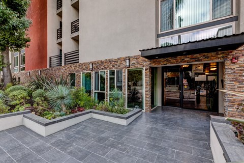 A building with a stone wall and a glass door.