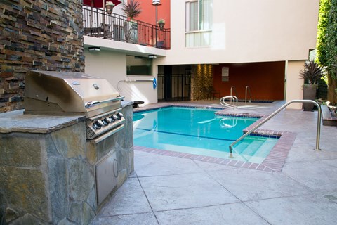 A pool with a hot tub and a patio area.