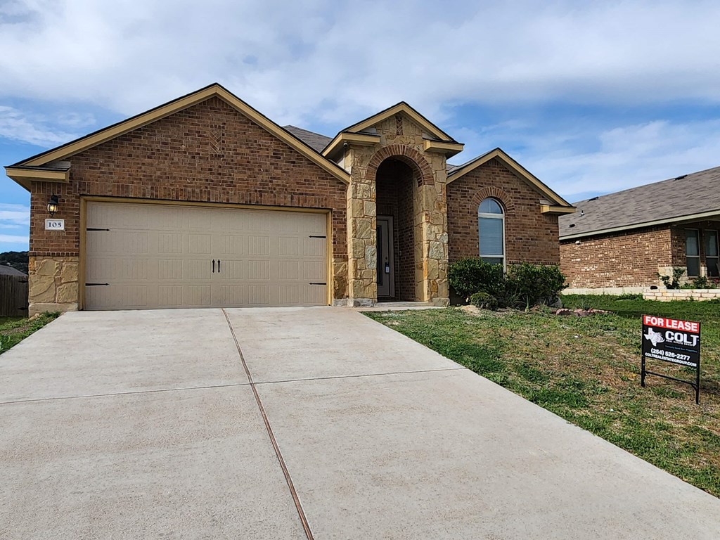 a house with a for sale sign in front of it