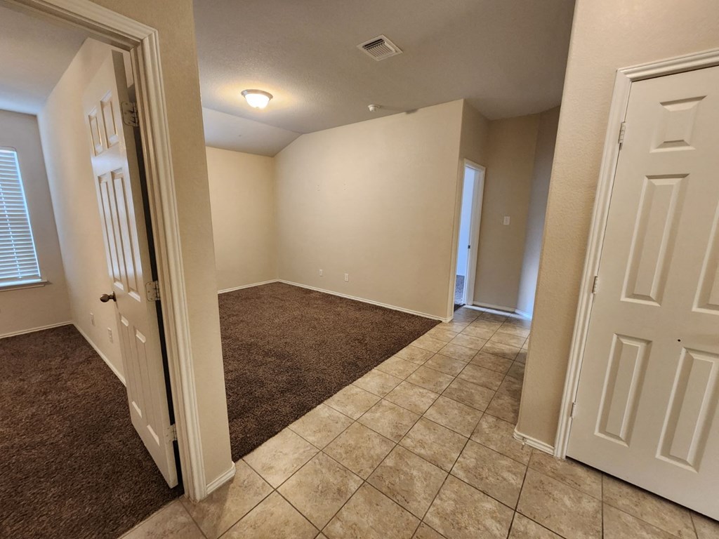 a room with a carpeted floor and white walls