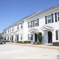 a large white building with a street in front of it