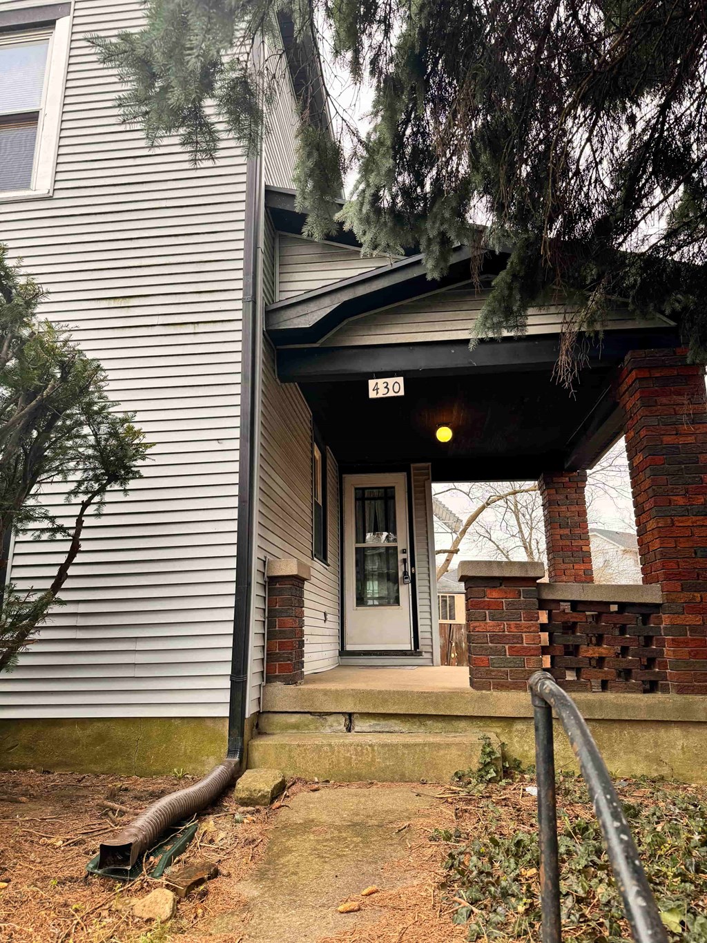 the front of a building with stairs and a door