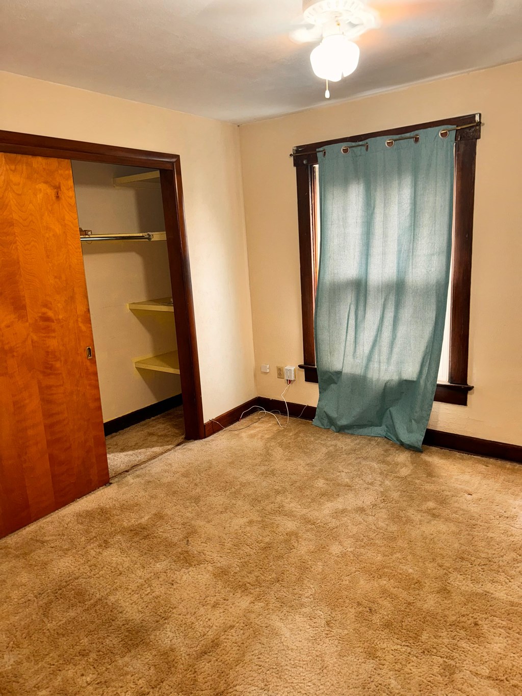 a room with a blue curtain in it and a closet