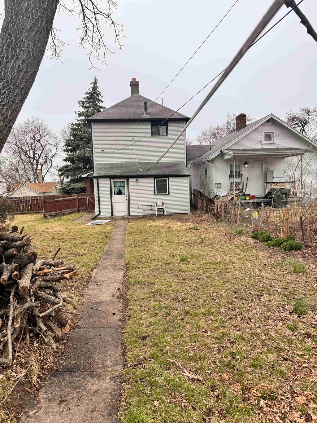 a white house with a yard and a sidewalk