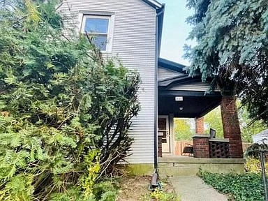 a white house with a sidewalk in front of it