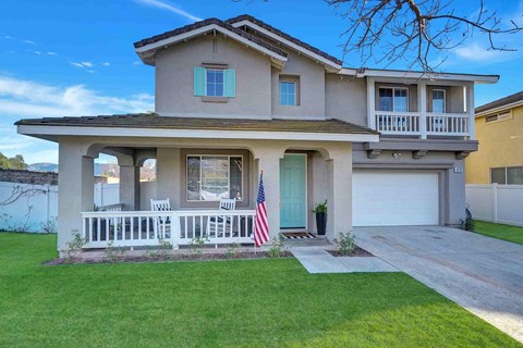 a house with an flag on the front porch