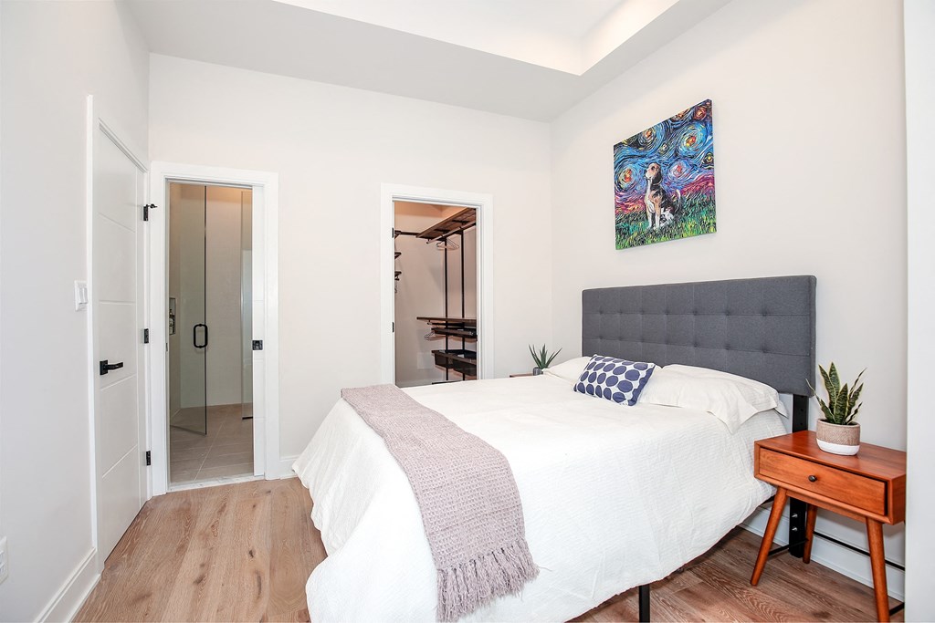 a bedroom with a bed and a door to a bathroom