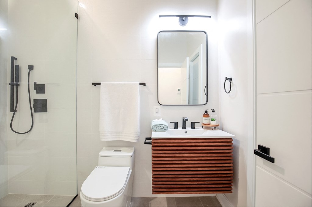 a bathroom with a toilet sink and a mirror