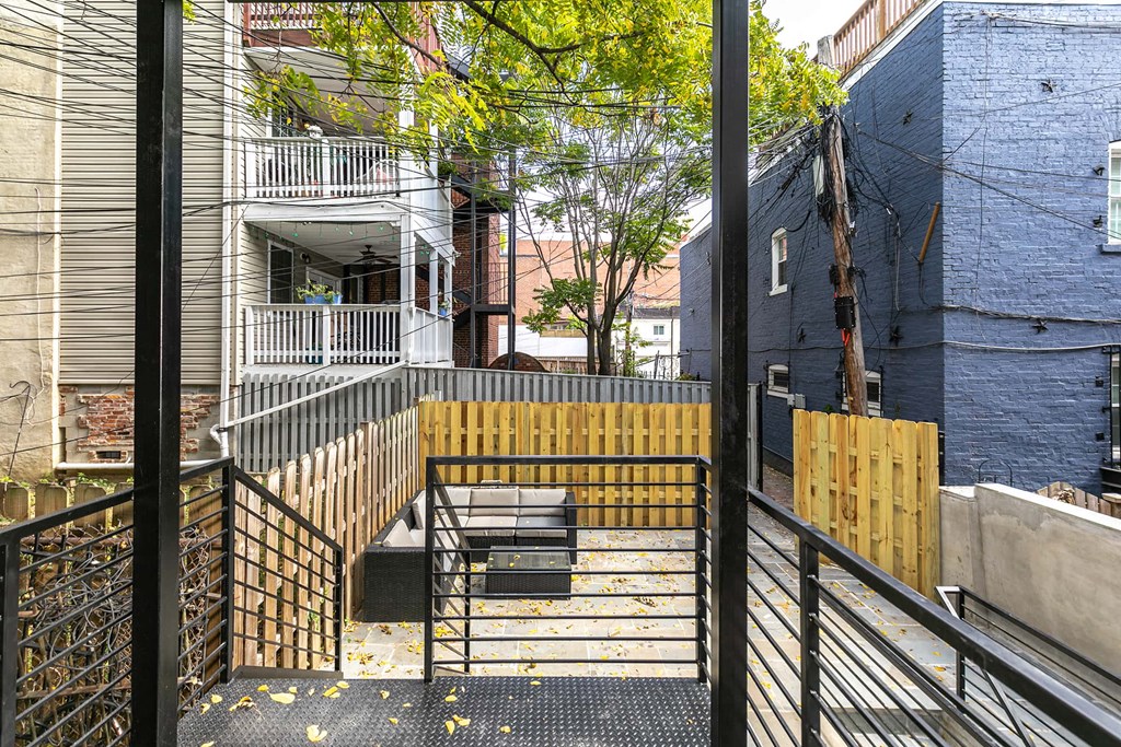 the view from the balcony of an apartment building with stairs and a fence