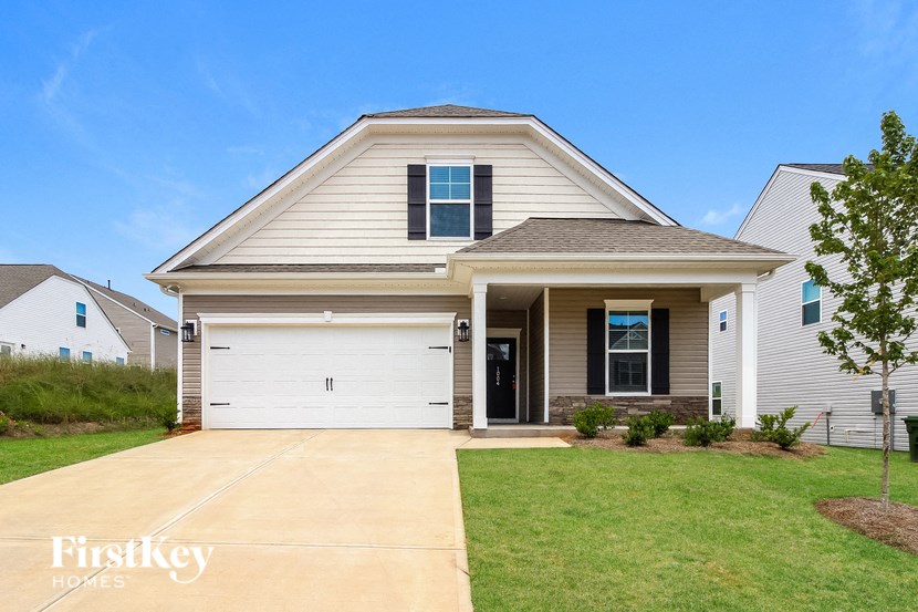 a house with a white garage door and a lawn