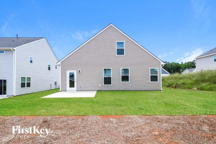 a white house with a yard in front of it