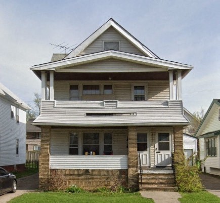 a white house with a white porch and