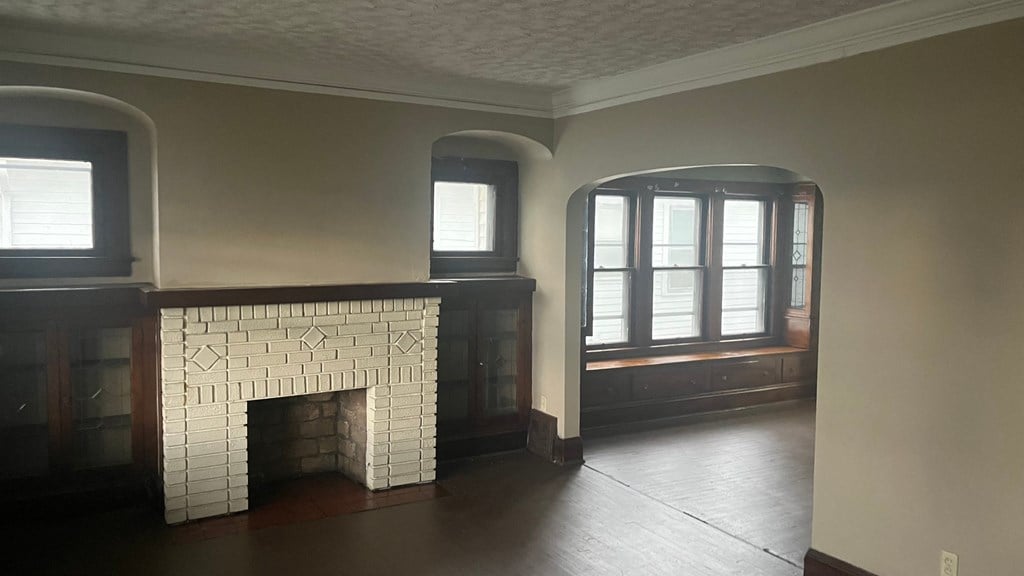 a living room with a fireplace and a window