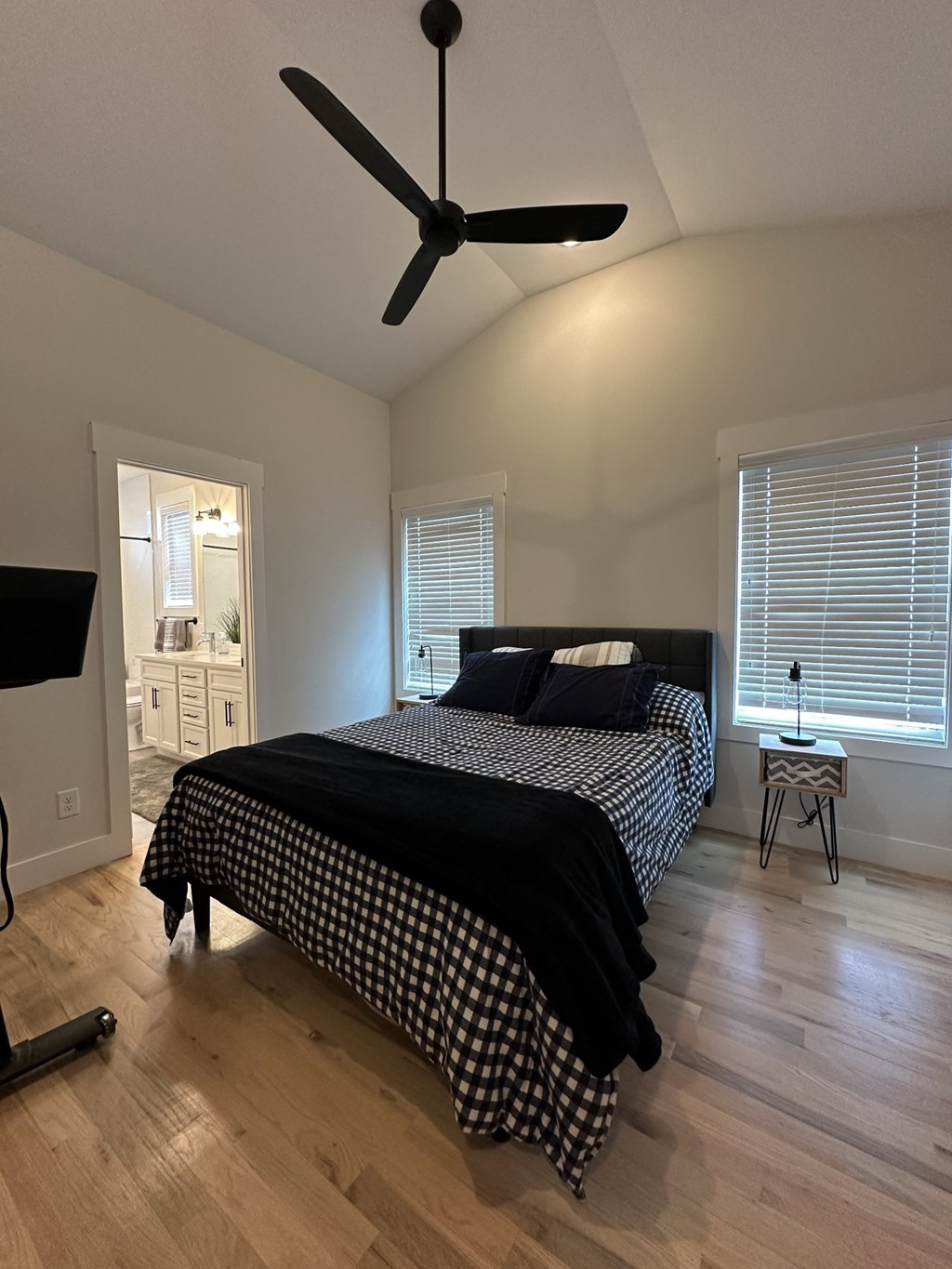 a bedroom with a bed and a ceiling fan