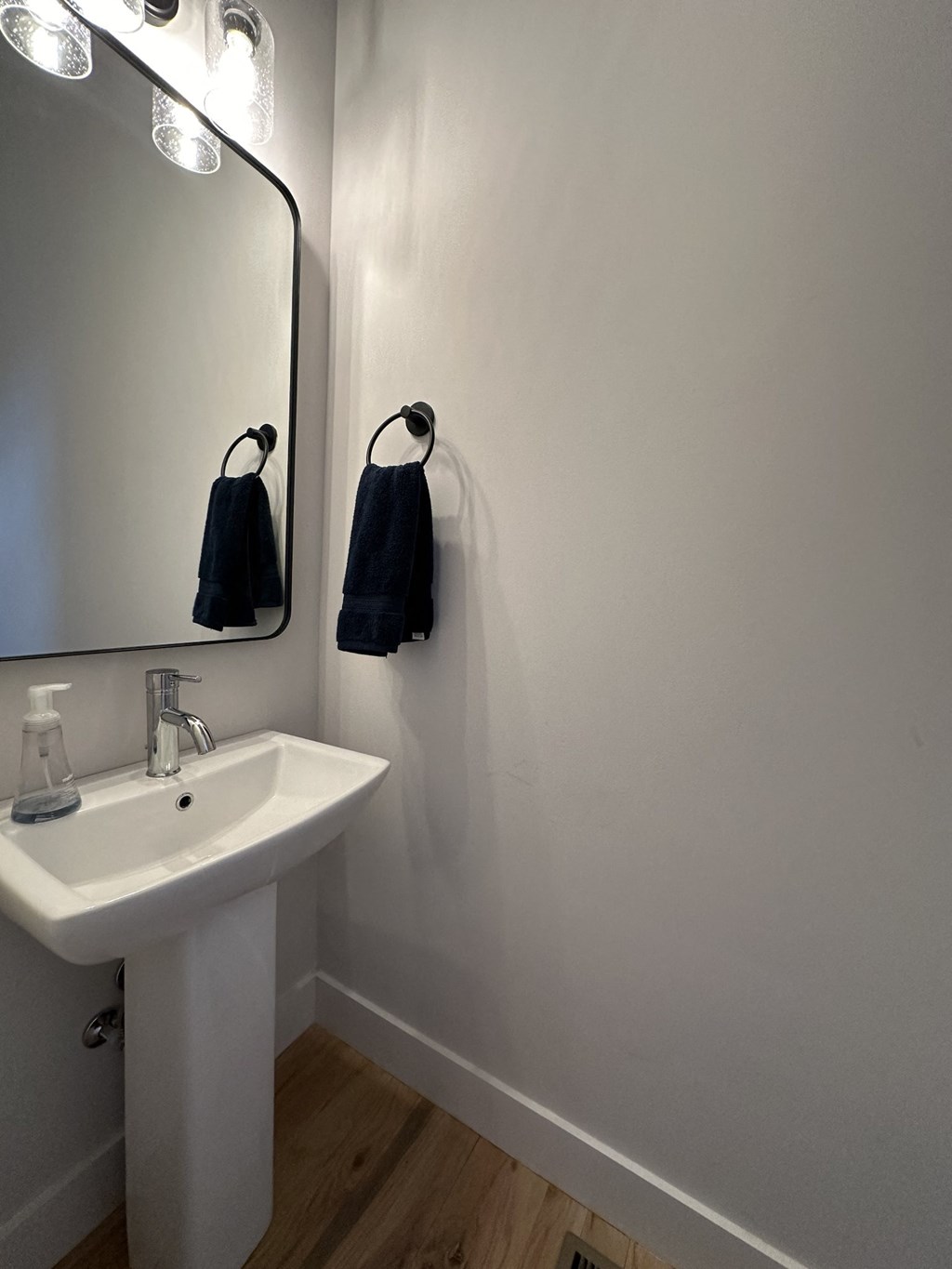 a small bathroom with a sink and a mirror