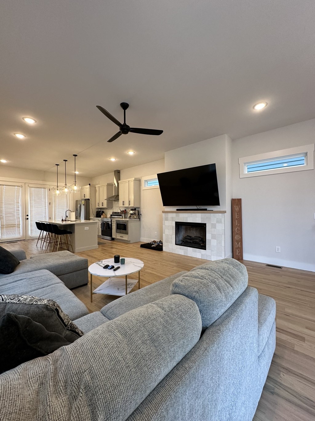 a large living room with a couch and a tv