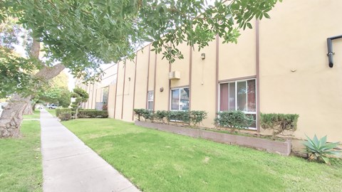 A building with a green lawn in front.