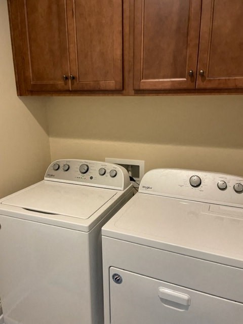 a kitchen with two white appliances and wooden cabinets
