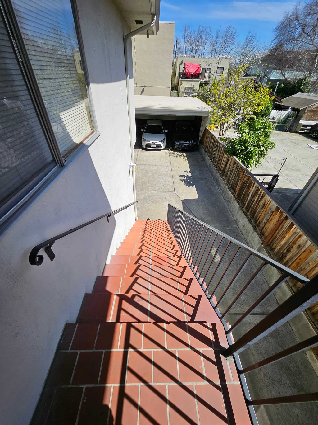 a view from the stairs down to the courtyard of a house