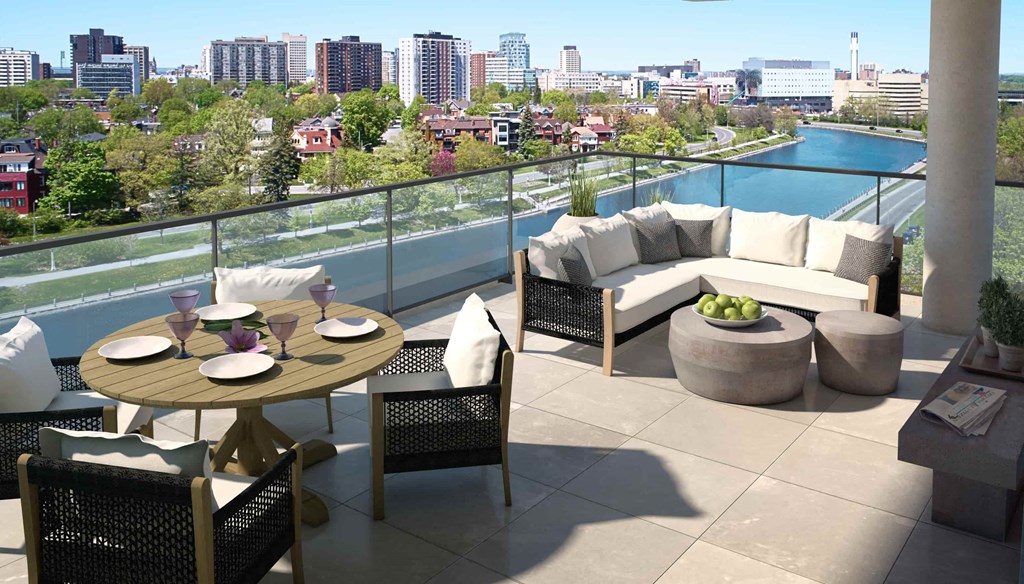 a terrace with a table and chairs on a balcony