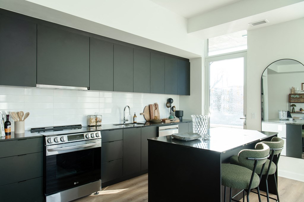 a kitchen with black cabinets and a white counter top