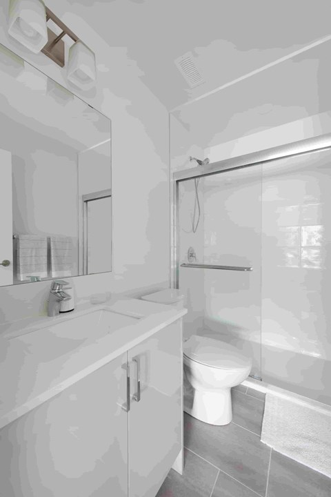 a white bathroom with a toilet and a sink