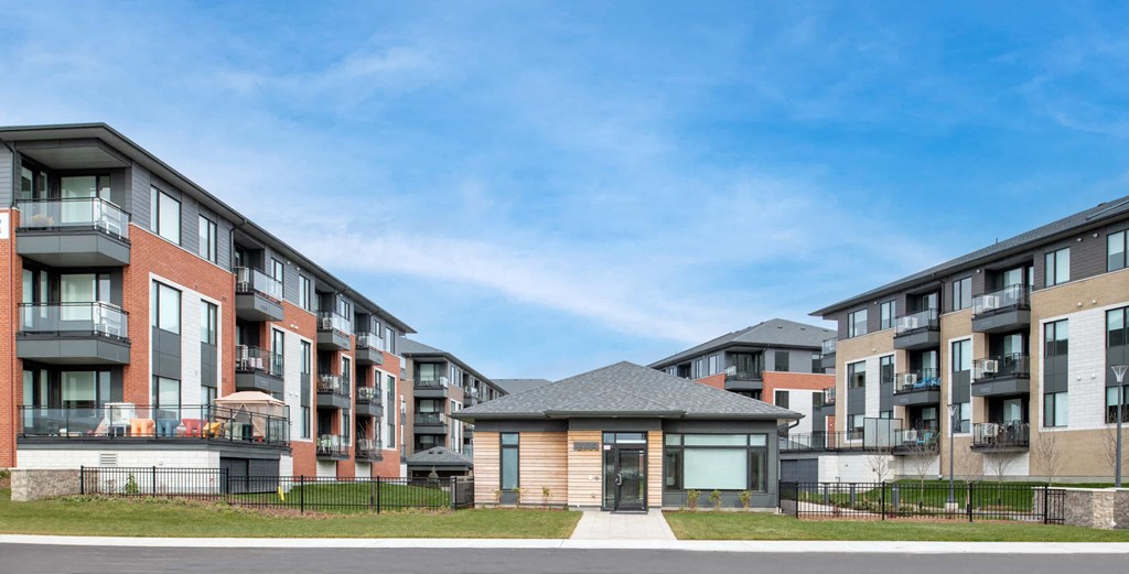 modern apartment buildings on the side of a street