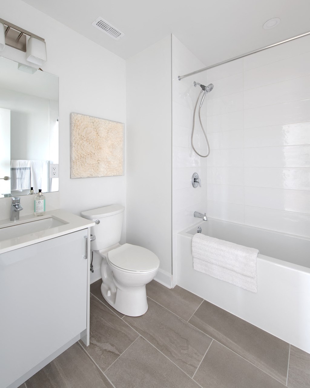 a white bathroom with a toilet and a shower