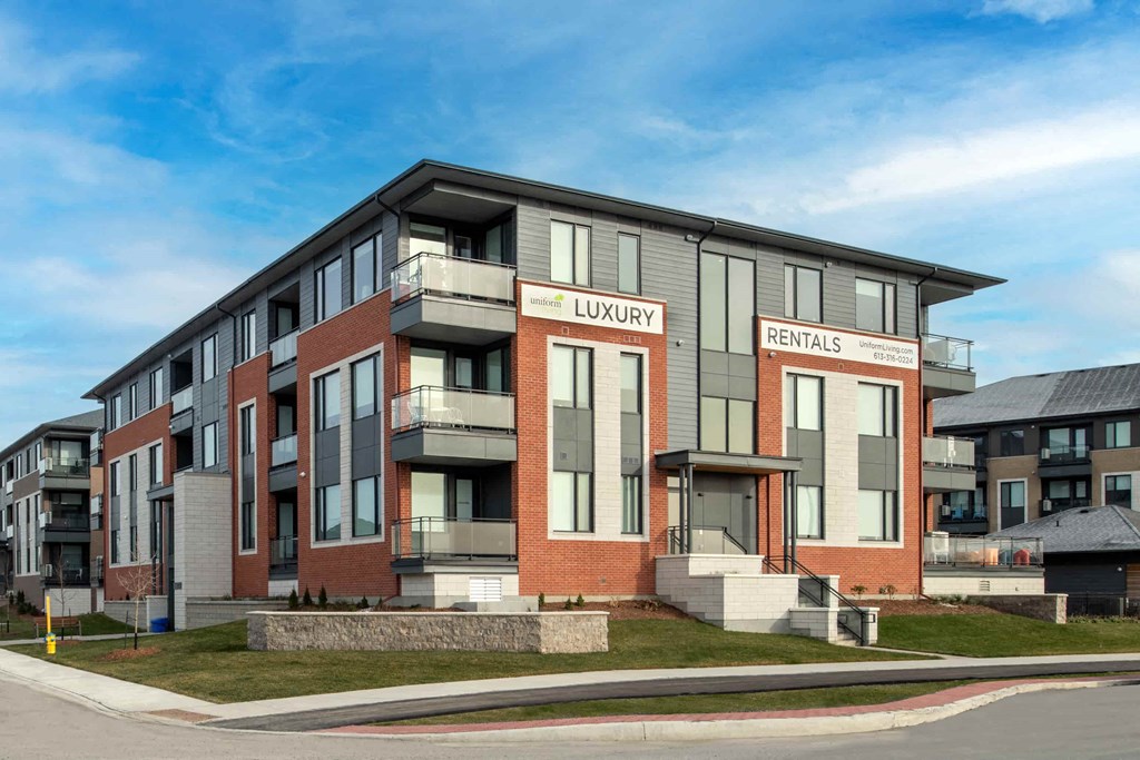 a rendering of a new apartment building on the corner of a street