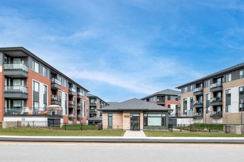 a row of apartment buildings on the side of a street