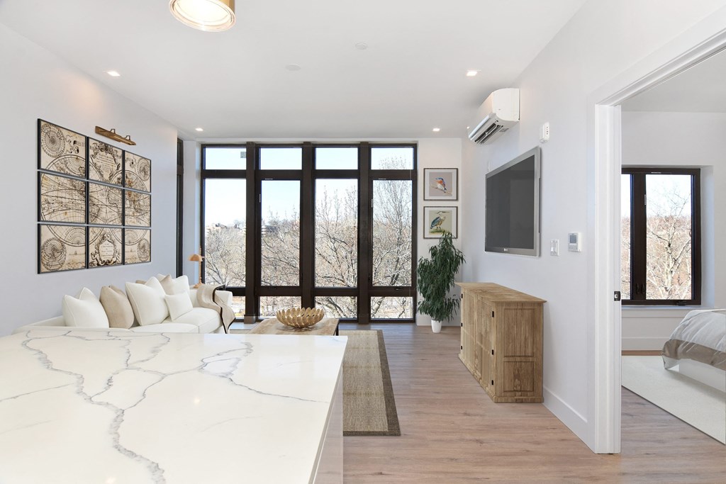 a living room with a white couch and a television