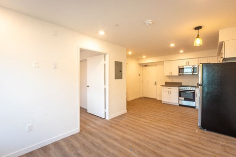 A kitchen area with a refrigerator, microwave, and oven.