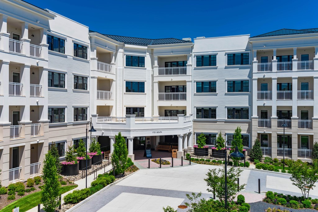 A white building with balconies and a courtyard in the center.