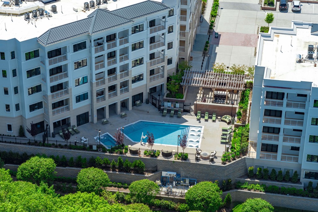 A large white building with a pool in the middle of a courtyard.