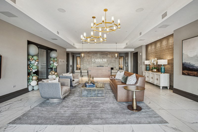 a living room with couches and a chandelier